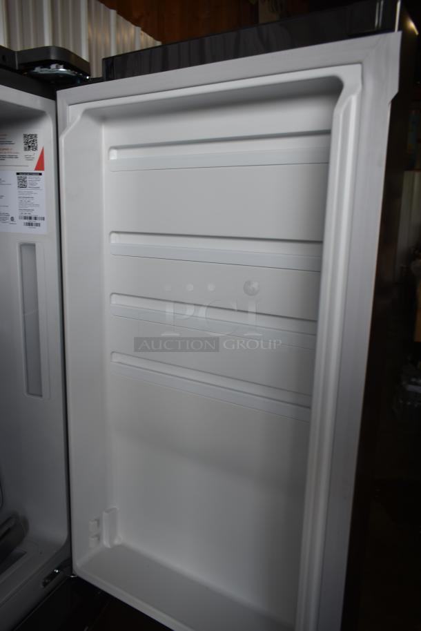 Open refrigerator door displaying interior shelves. Visible label indicates model details and specifications. Excellent condition.