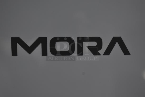 MORA logo on a matte surface, black text on gray. No visible wear or additional markings.