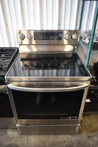 Stainless steel electric range with glass cooktop, control knobs, digital display, and spacious oven in excellent condition.