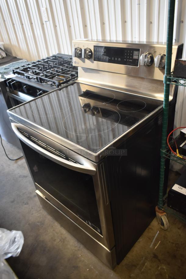 LG stainless steel electric range with smooth cooktop, control panel, and oven. Modern design, excellent condition.