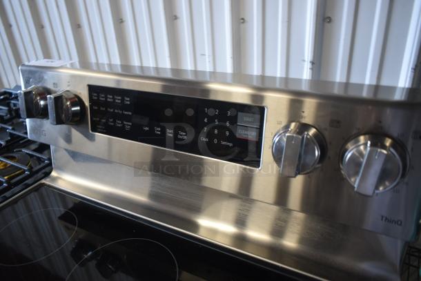LG stainless steel gas range, model ThinQ, features digital controls and knobs. Excellent condition, minor surface marks.
