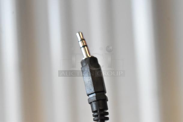 Black 3.5mm audio jack plug in good condition, standard connector for audio devices.