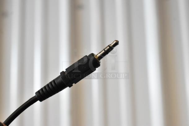 Close-up of a 3.5mm audio jack plug with black casing. The plug shows minimal wear, indicating good condition.