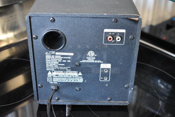 Back panel of an iLive IHB23B wireless speaker with subwoofer, featuring audio input, power source details, and caution warnings.