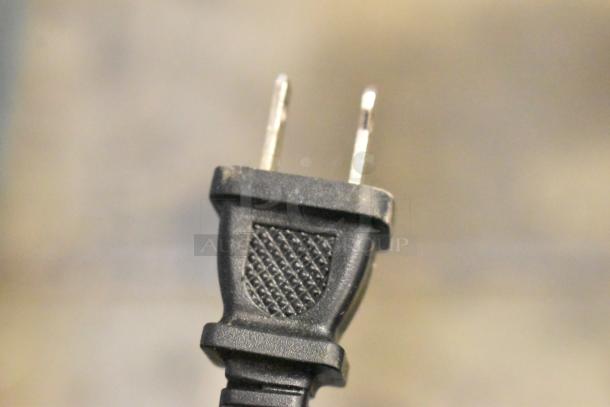 Close-up of a standard two-prong black electrical plug with textured grip, in good condition.