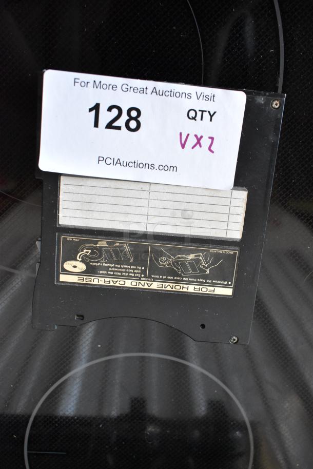 Vintage vinyl record on turntable with auction tag 128. Includes instruction label for home and car use.