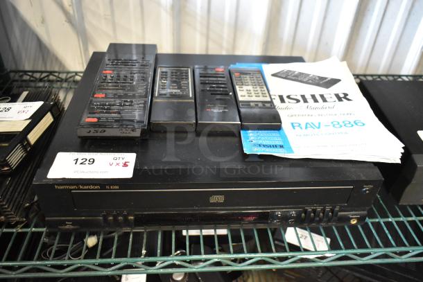 Harman Kardon FL8300 CD player with multiple remote controls and a Fisher RAV-886 manual. Auction item 129.
