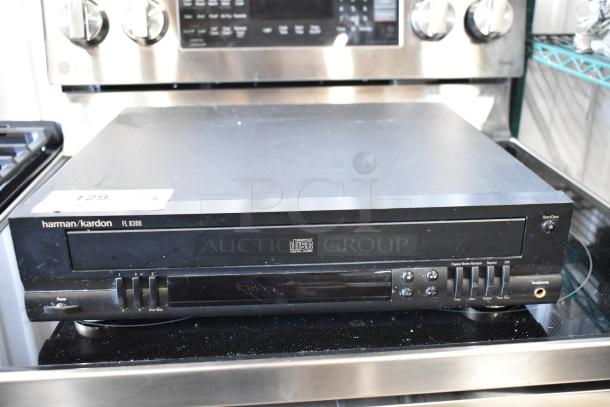 Harman Kardon FL 8300 CD player, black, visible scratches, digital audio, auction tag "129".