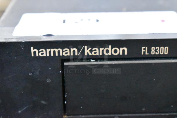 Harman Kardon FL 8300 CD player in used condition, with visible minor scuffs on the surface. Brand and model logo displayed.