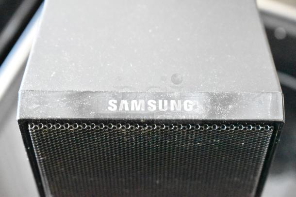 Samsung speaker with black mesh grille, slightly dusty. Brand logo visible, indicating authenticity. Good condition.