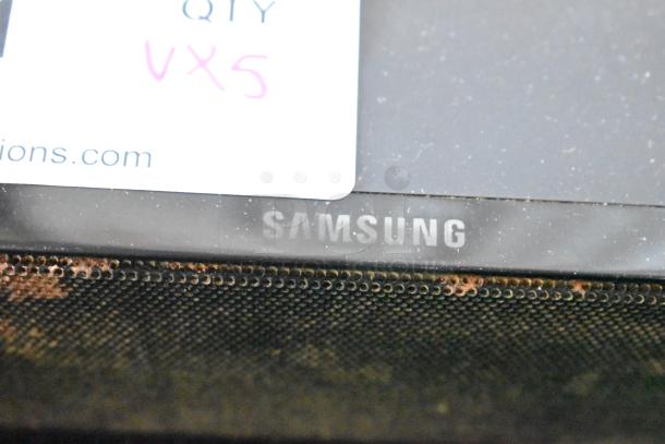 Samsung electronic device with a visible label marked "Qty VX5." Device shows signs of wear on the surface.