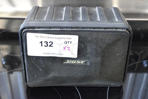 Bose speaker, vintage design. Moderate wear visible. Label reads "132 QTY x2" from PCI Auctions.