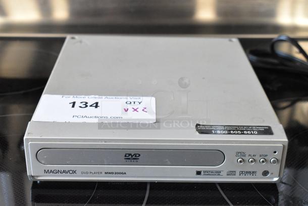 Magnavox DVD Player MWD200GA, silver, with operational buttons, used condition. Label visible with auction info.