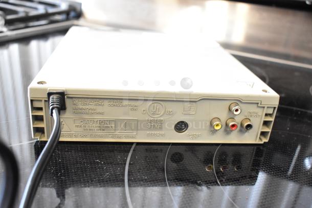Vintage electronic device featuring RCA connectors, S-video, and digital audio out. Markings indicate UL listing and 120V power input.