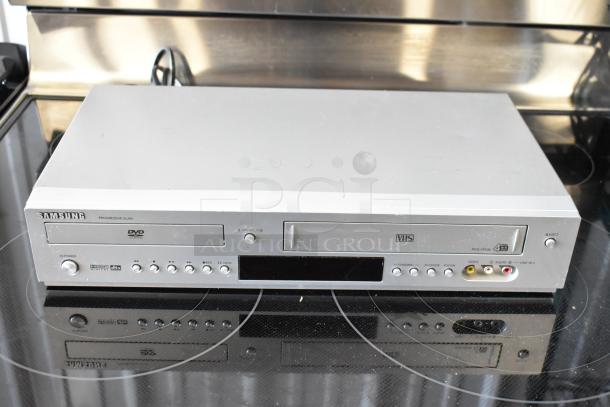 Samsung DVD-V3500 DVD/VHS player, silver, progressive scan, minor surface wear, front input ports, power and control buttons.