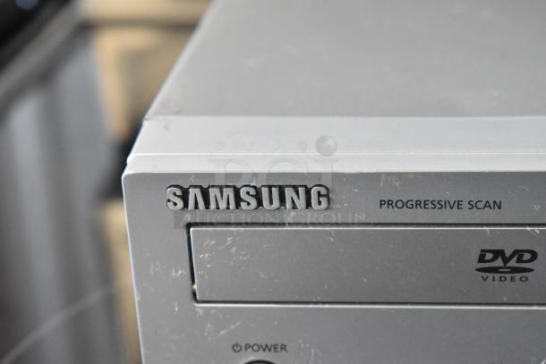 Samsung DVD player with progressive scan; shows signs of wear. Marked with "DVD Video" logo and "Power" button.