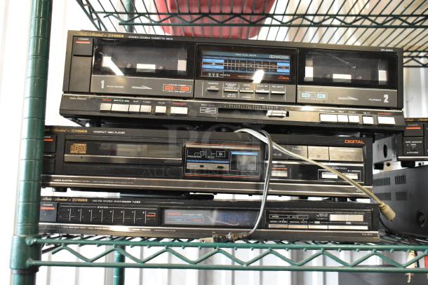 Vintage Fisher stereo system with cassette deck, CD player, and AM/FM tuner. Features include dual tape decks, digital audio, and synthesizer tuning.