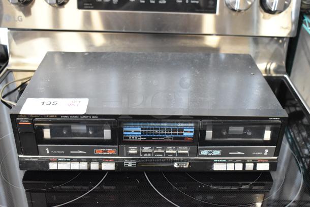 Fisher stereo double cassette deck CR-W870, vintage audio equipment, black, visible label "135," buttons and meters intact.
