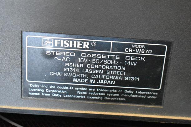 Fisher stereo cassette deck, model CR-W870, 16V, 50/60Hz, 14W, made in Japan. Label includes address and Dolby trademark.