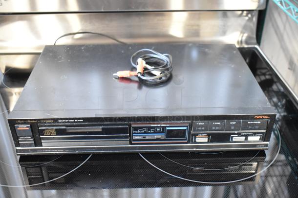 Vintage Fisher AD-870 CD player, black, with digital display and connectors. Some surface wear visible.