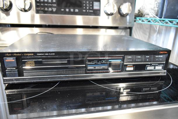Vintage Fisher Studio-Standard AD-870 compact disc player in used condition with front panel buttons and digital display.