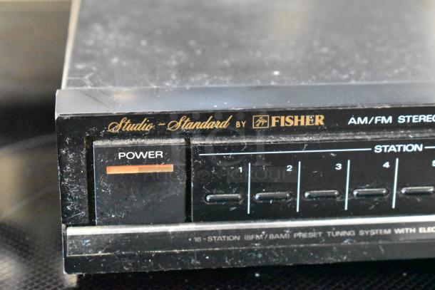 Vintage Fisher Studio-Standard AM/FM Stereo Tuner, 16-station presets, power button visible, surface wear present.