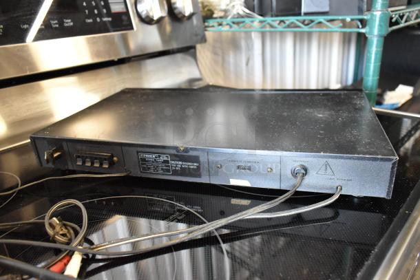 Vintage Fisher Stereo Tuner, model FM-864; scratched black exterior, rear label with connections, some visible wear.