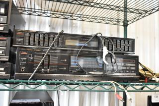 Vintage Fisher stereo system with equalizer and integrated amplifier, black finish, used condition. Model numbers visible.