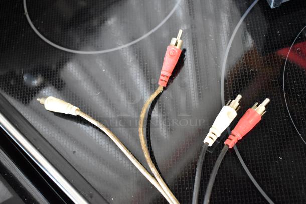 Vintage RCA cables with red and white connectors, showing minor wear. Suitable for audio connections, no visible brand labels.