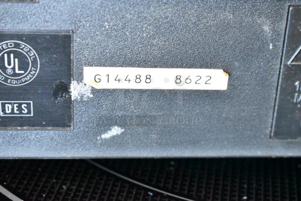 Dark surface with UL certified label and tag marked "G14488 8622," indicating model or serial number. Minor wear visible.