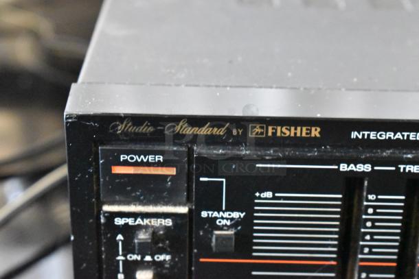 Fisher Studio-Standard integrated amplifier with power and speaker controls showing slight wear.