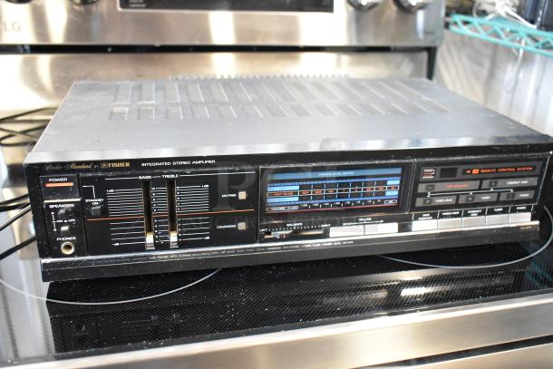 Vintage Fisher integrated stereo amplifier with sliders and dials; features include power level meter and remote control system.