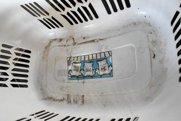 White plastic laundry basket with vented sides, showing signs of grime and wear inside. Features a label with clothing graphics and logos.