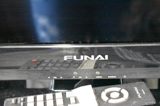 Funai TV with visible control buttons and remote. Model engraved on remote, visible wear and dust on surfaces.