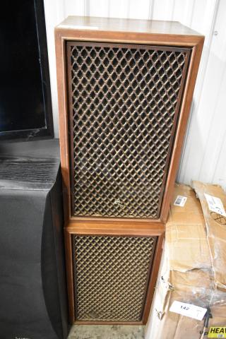 Vintage wood-cased speakers with lattice grills, in good condition, minor wear. Unmarked, stackable design.