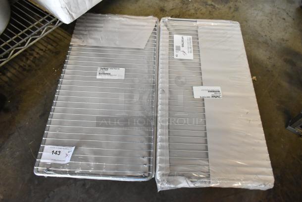 Two Delfield OEM stainless steel wire shelves, new, labeled as part 3077989, in original packaging, Qty 1, lot 143.