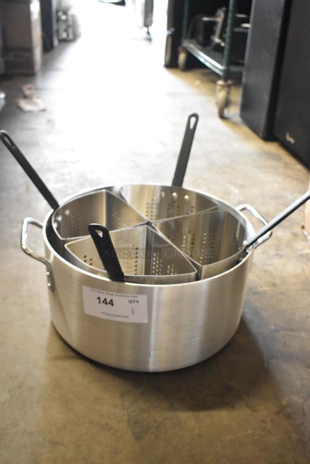 Large stainless steel cooking pot with four perforated inserts and black handles. Auction tag reads "144 QTY 1".