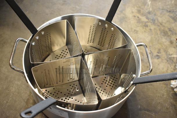 Stainless steel pasta cooker with four perforated inserts, dual handles, black grips. In excellent condition.
