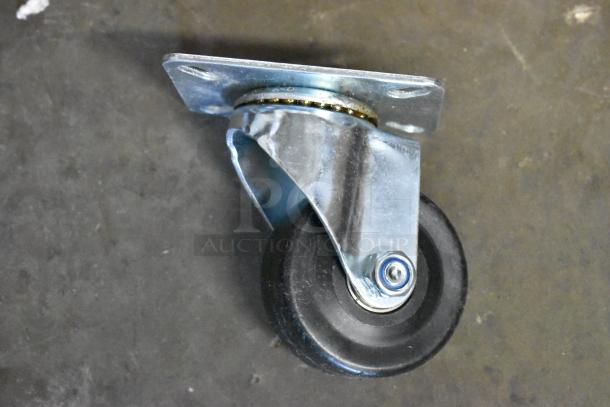 Swivel caster wheel with metal mounting plate, black rubber wheel, and silver finish, in good condition.