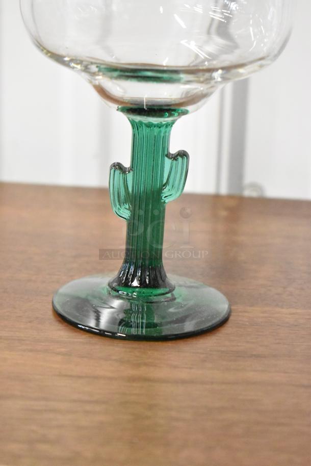 Unique margarita glass with green cactus-shaped stem, clear bowl, excellent condition. Ideal for collectors or themed décor.