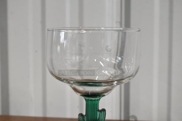 Vintage clear glass goblet with a green twisted stem, excellent condition, featuring a wide bowl and smooth rim.