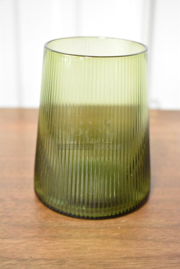 Green ribbed glass vase, cylindrical shape, glossy finish, excellent condition, height approx. 8 inches.