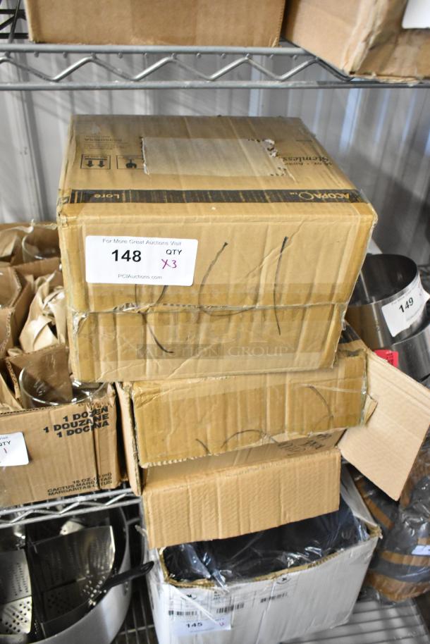 Stacked brown cardboard boxes on a metal shelf, labeled "148 QTY X3," indicating auction quantity. Boxes show minor wear.
