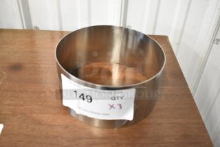 Stainless steel ring mold, excellent condition, with auction label indicating lot 149, quantity of three.
