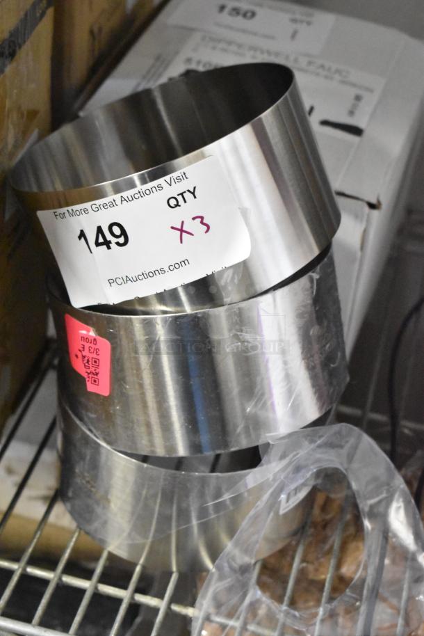 Set of three stainless steel rings for baking or cooking. Labels indicate auction lot 149. Excellent condition.