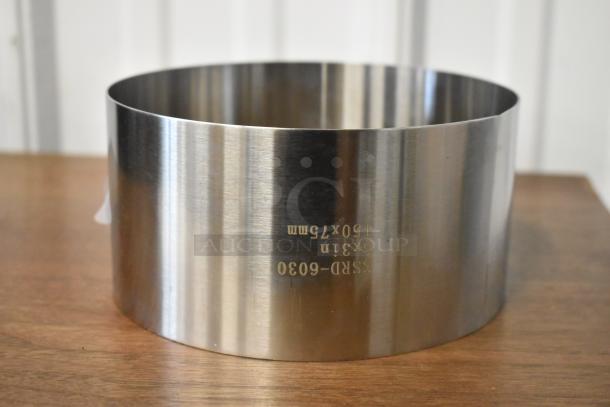 Stainless steel ring, 6x3 inches, model 555RD-6030, marked 150x75mm, on wooden surface. Appears unused.