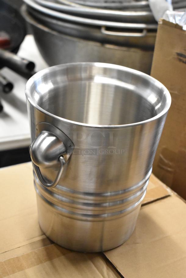 Stainless steel ice bucket with side handle, polished finish, good condition, ideal for barware collection.