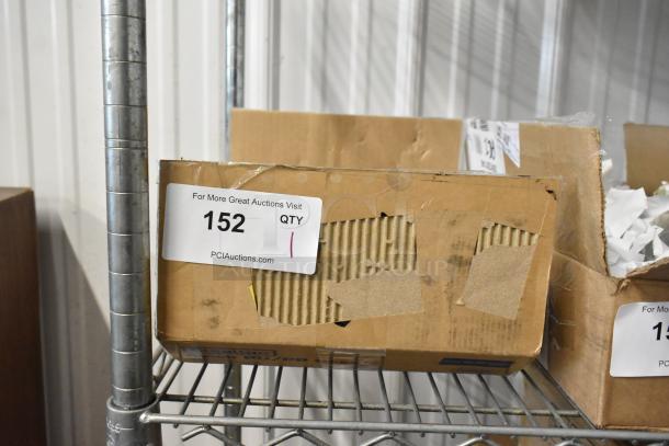 Cardboard box with label "152 QTY" from PCIAuctions.com, visible damage, stored on metal shelf.