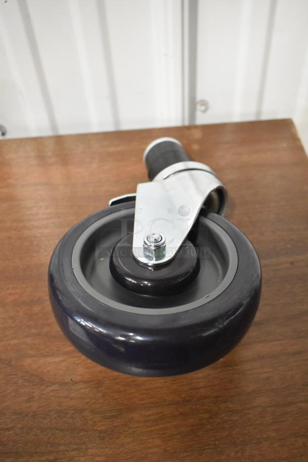 Swivel caster wheel with black rubber tire, metal bracket, and locking mechanism, in good condition.