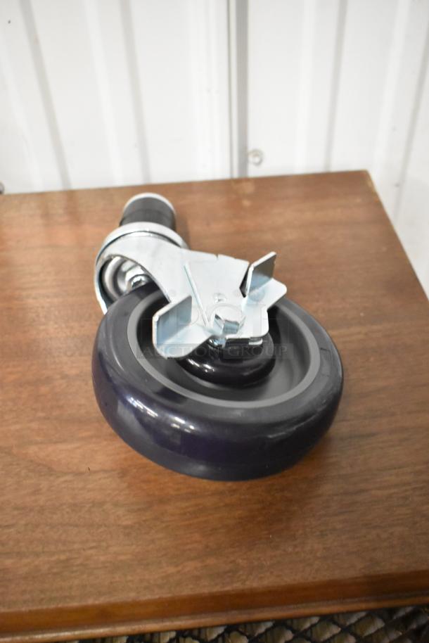 Heavy-duty caster wheel, grey rubber tire with metal bracket, swivel mount, like-new condition.